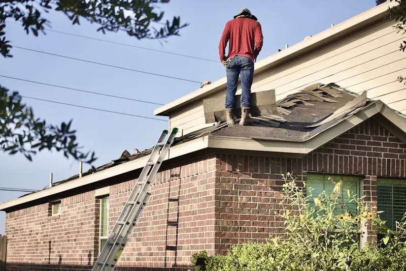 Professional roofer working on a residential roof in Muskego